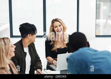 Happy group of colleagues having a brainstorming session. Laugh, friendly and smiling employees working together as a team for business ideas. Diverse Stock Photo
