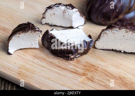 white creamy marshmallows in milk chocolate, delicious sweets of eastern Europe marshmallows in chocolate glaze with cream filling Stock Photo