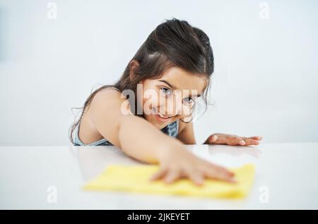 I reached it. an adorable little girl helping out with chores at home. Stock Photo