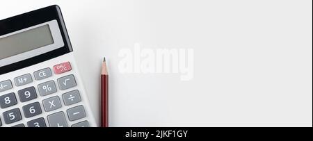 Calculator with pencil on grey background. Business report concept. wide banner, copy space. Close up of calculator and red pencil Stock Photo