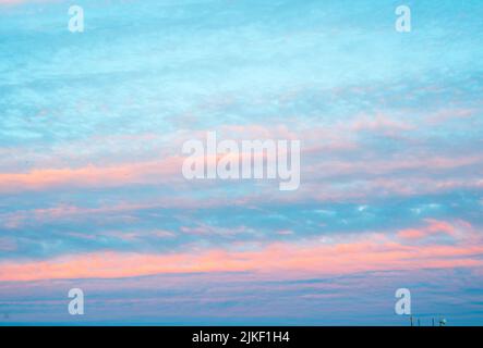 Panorama of sky with pink clouds at sunset or sunrise. Abstract background with pink, purple and blue colors clouds. Light pink clouds in sunset blue Stock Photo