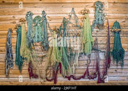 Different fishing nets hang on a wall a decor texture Stock Photo