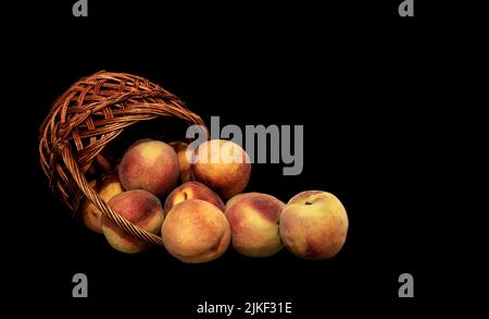 Image of ripe peaches poured out of the basket Stock Photo