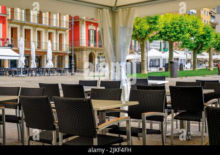 Tables at one of many outdoor cafes on historic Plaza del Castillo in Old Town Pamplona, Spain famous for running of the bulls Stock Photo
