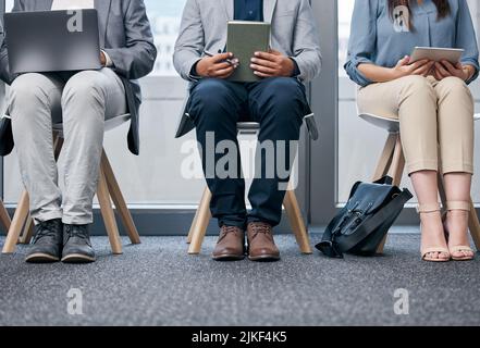 Preparation can take you far. unrecognizable businesspeople sitting in a row in a waiting room. Stock Photo