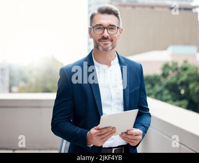 Put some respect on my name. Portrait of a mature businessman using a digital tablet outside. Stock Photo
