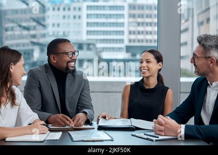 Meetings keep everyone focused and productive. a group of corporate business colleagues having a meeting around the table in the boardroom. Stock Photo