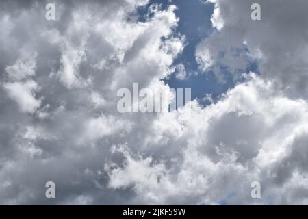 Cumulonimbus cloud formations on tropical blue sky , Nimbus moving , Abstract background from natural phenomenon and gray clouds hunk , Thailand Stock Photo