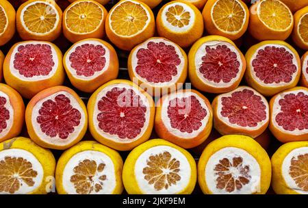 Orange, grapefruit sliced are sold on the counter of a fruit shop on Istanbul street. Fruit background. Stock Photo
