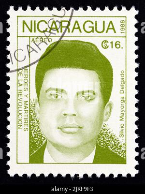 NICARAGUA - CIRCA 1988: A stamp printed in Nicaragua from the 'Revolutionaries' issue shows Silvio Mayorga Delgado, circa 1988. Stock Photo