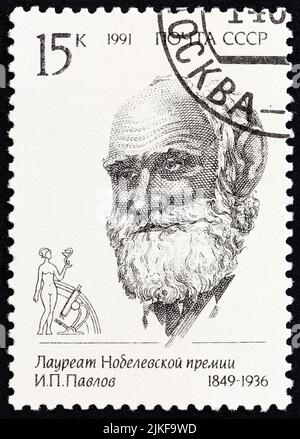 USSR - CIRCA 1991: A stamp printed in USSR from the 'Nobel Prize Winners' issue shows Ivan Petrovich Pavlov, 1849-1936, circa 1991. Stock Photo