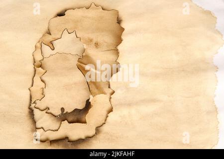 aged paper layers burnt edges stained background Stock Photo