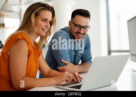Programmers cooperating at IT company developing apps Stock Photo