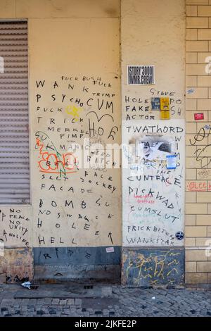 BERLIN, GERMANY - APRIL 6, 2019: Berlin wall covered in expletives scrawled on it in marker in Berlin, Germany on April 6, 2019. Stock Photo