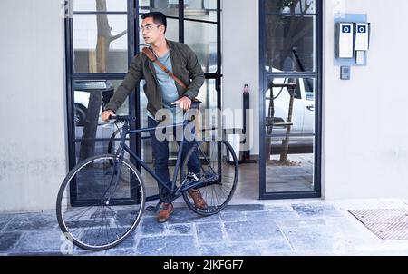 Finally able to enter. a young man using a bicycle in the city. Stock Photo