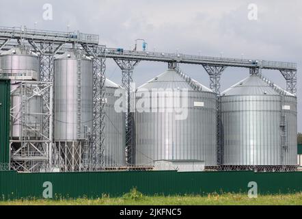 Modern large granary agro silos elevator on agro-processing manufacturing plant for processing drying cleaning and storage of agricultural products, f Stock Photo