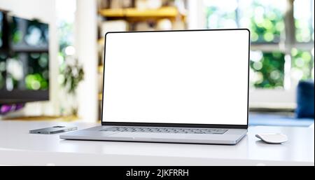 Laptop with frameless blank screen on table in  home interior Stock Photo