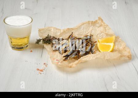 Fatty smoked smelt in wrapping paper Stock Photo