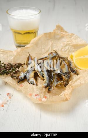 Fatty smoked smelt in wrapping paper Stock Photo