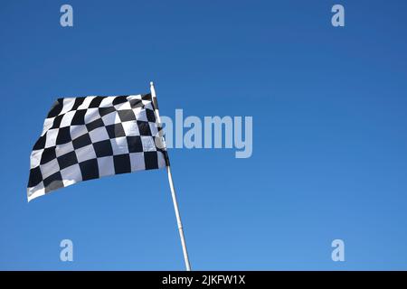 chequered flag against blue sky
