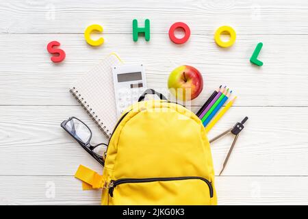 Yellow school backpack with student accessories. College and school concept Stock Photo