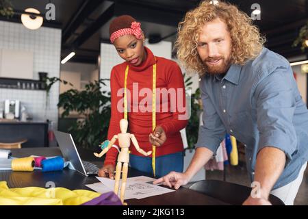 Multiracial female fashion designers discussing in office studio Stock ...