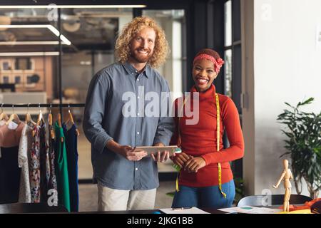 Portrait of smiling multiracial male and female colleagues standing in office Stock Photo