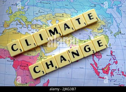 Climate Change , Global Warming spelled out in Scrabble letters on a map Stock Photo