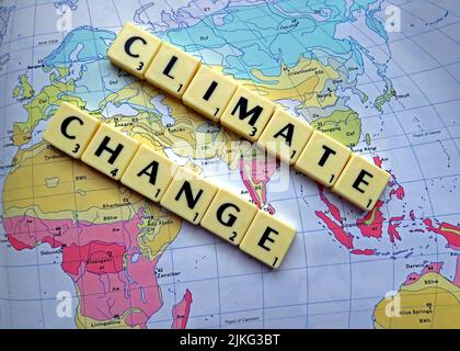 Climate Change , Global Warming spelled out in Scrabble letters on a map Stock Photo