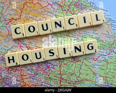 Council Housing spelled out in Scrabble letters on a map of England, a policy already rejected by Scotland and Wales assembles Stock Photo