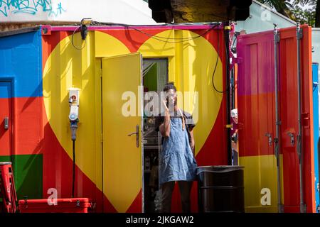 A cafe worker takes a break on the Southbank Centre, London, UK. Stock Photo