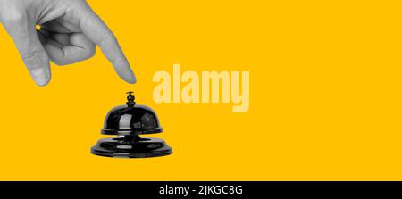 Banner with forefinger pressing on call bell on orange background. Paying attention concept. Stationary construction used in hotel, restaurant, store. Copy space. High quality photo Stock Photo