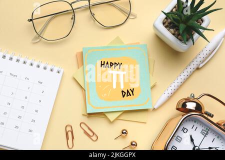 Composition with stationery, calendar, clock and glasses on beige background. Happy Pi Day Stock Photo