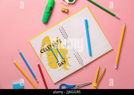 Notebook with text CELEBRATE PI DAY and stationery on pink background Stock Photo