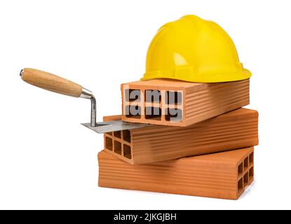 Trowel, bricks and hhardhat isolated on white background Stock Photo