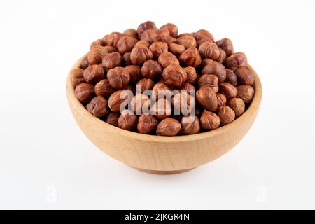 Bowl full of hazelnuts  on white background Stock Photo