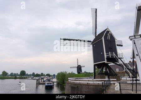 Heusden, Brabant, the Netherlands - May 7, 2022: Windmills in the Dutch fortress city Heusden. Stock Photo