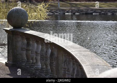 A beautiful view of a park embankment near a river on a sunny day Stock Photo
