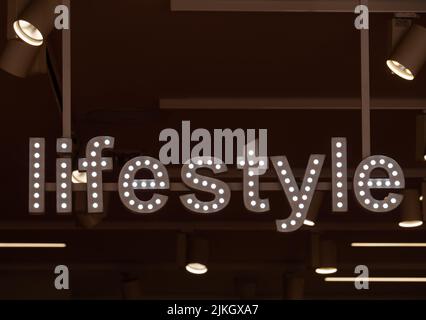 illuminated sign with the word lifestyle on a dark background, Ronda, Malaga, Spain Stock Photo
