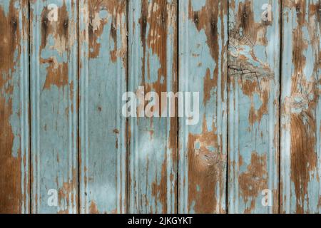 An old textured wooden surface with cracked paint and shadows Stock Photo