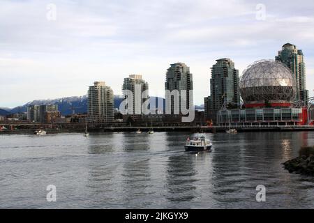 Small boat is crossing False Creek in Vancouver Stock Photo - Alamy