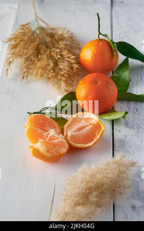 A closeup of fresh, juicy oranges on a white painted wooden surface Stock Photo