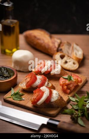 Tasty cheese slices and basil leaves on white background Stock Photo ...