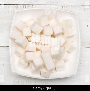 Refined sugar cubes on wooden background Stock Photo