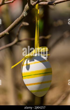 A beautiful shot of a decorative Easter egg hanging on a tree branch Stock Photo