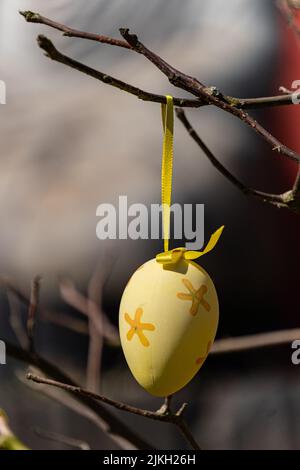 A beautiful shot of a decorative Easter egg hanging on a tree branch Stock Photo