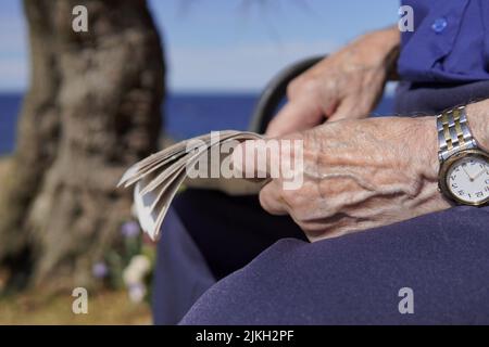 a senior man pointing at something in the newspaper Stock Photo