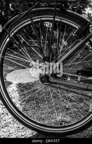 A vertical grayscale shot of the wheel on a bicycle Stock Photo
