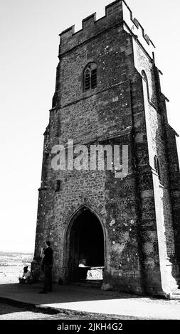 A grayscale shot of St Michael's tower on top of Glastonbury Tor hill in Somerset, England Stock Photo