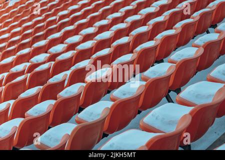 Aligned red lines of empty red theater seats with white snow Stock Photo